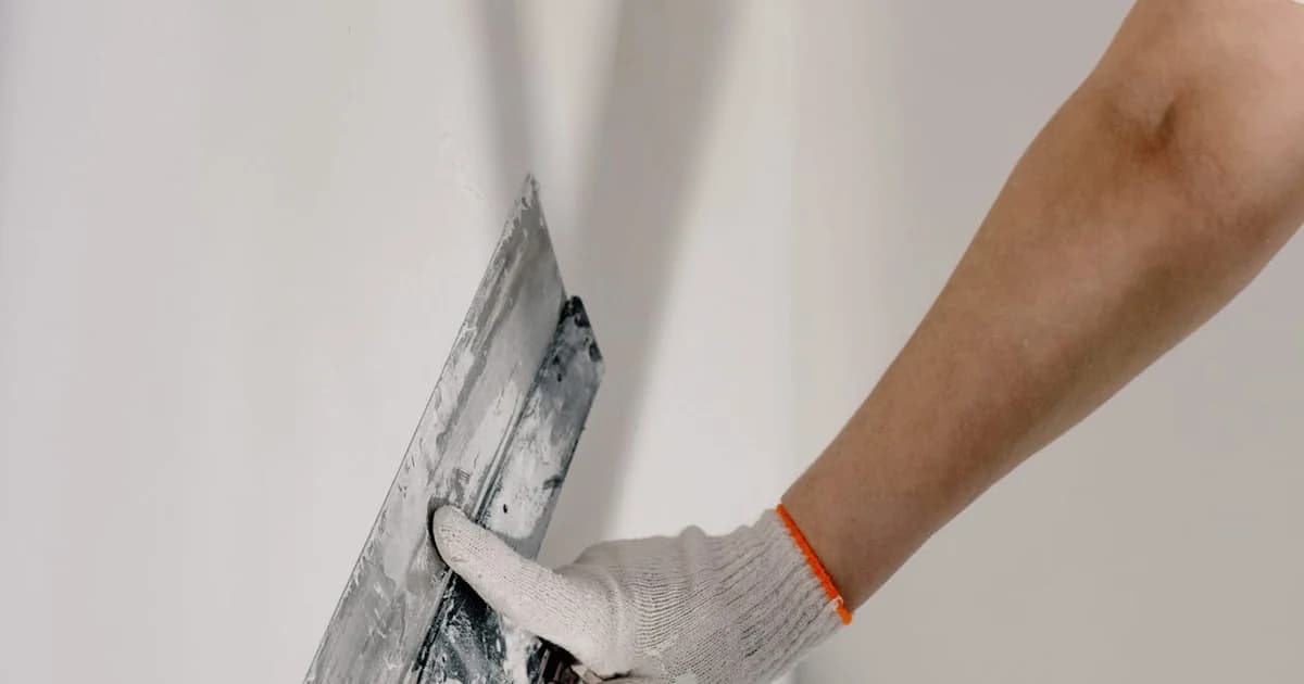 Multigenerational family sitting together on a sofa at home, representing NYC households navigating rent help and child care programs.