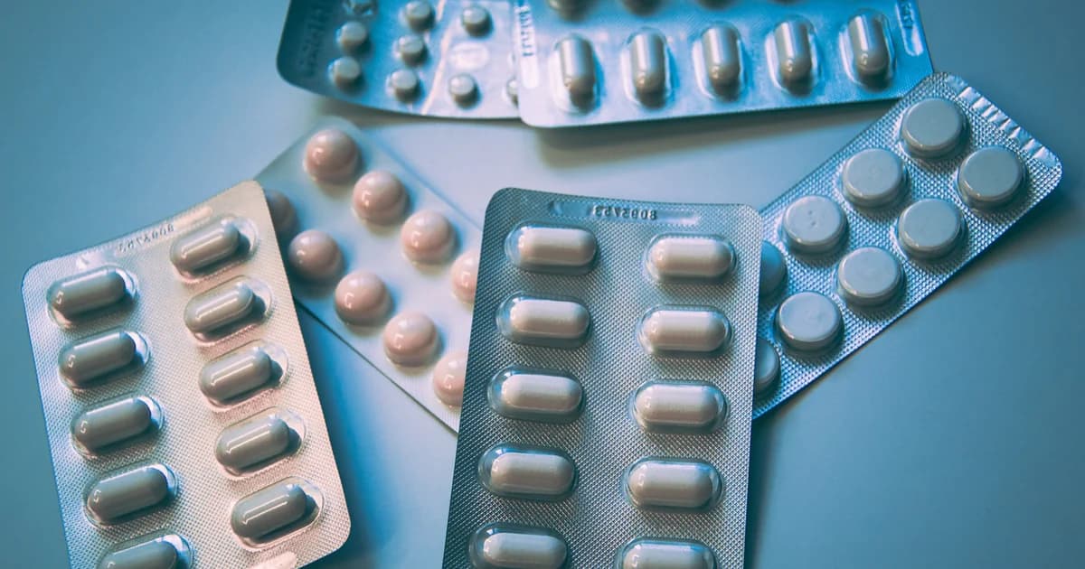 Blister packs with assorted capsules and tablets, illustrating health products plans may include under OTC-style allowances