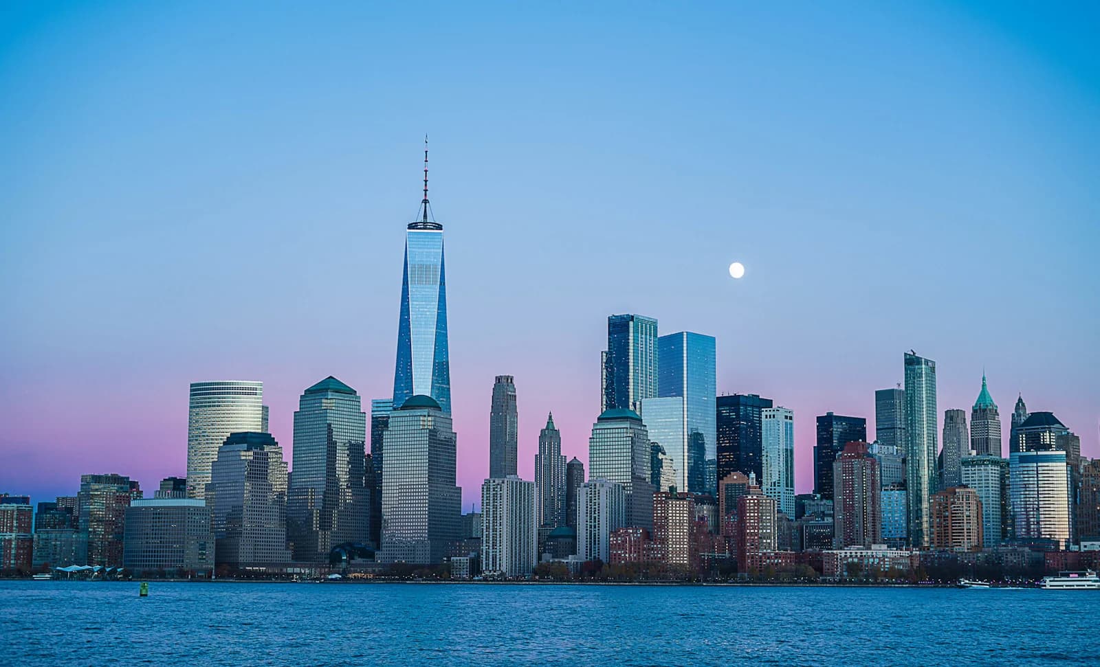 New York City skyline at dusk, suggesting a citywide guide to NYC benefits programs for residents across the five boroughs.