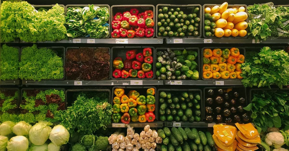 Fresh fruits and vegetables on grocery store shelves, illustrating healthy food shopping for NYC households using SNAP nutrition benefits.